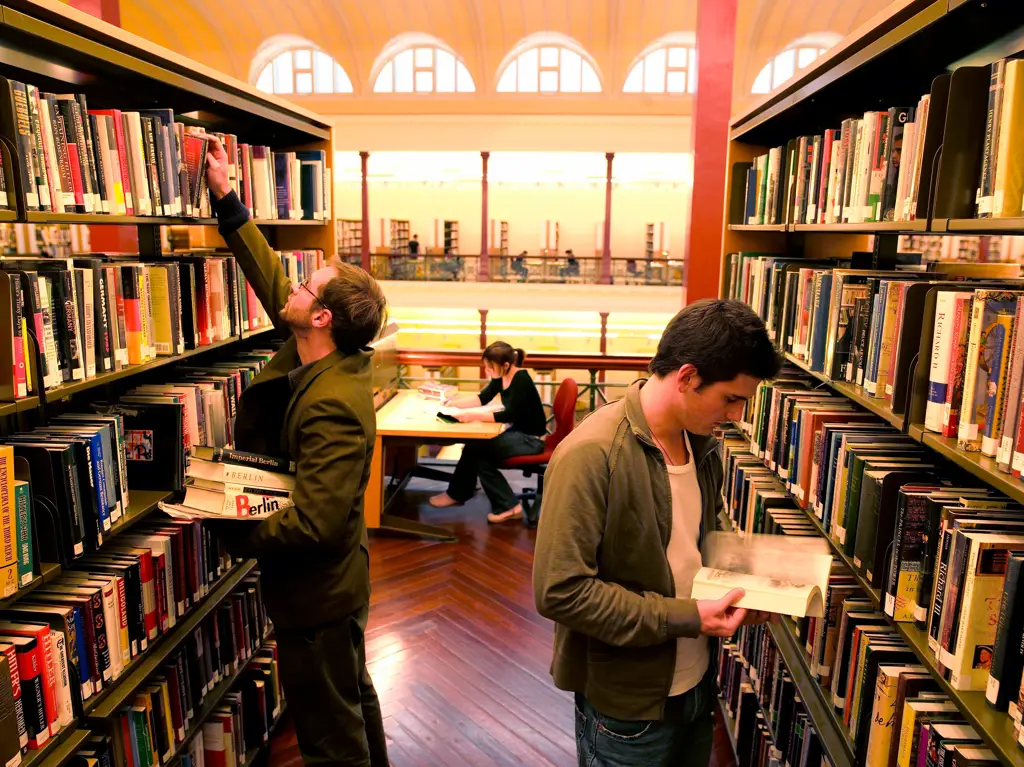 Gambar orang-orang yang sedang membaca buku di perpustakaan dengan tenang dan tertib