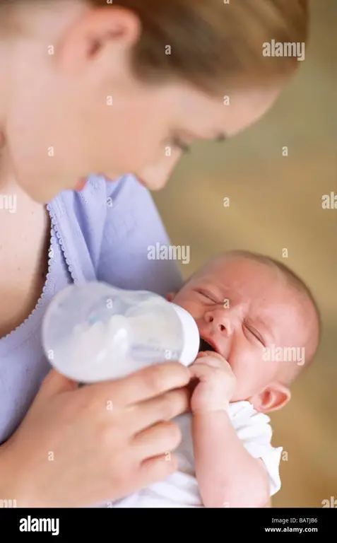 Ibu sedang memberi makan bayi dengan botol susu